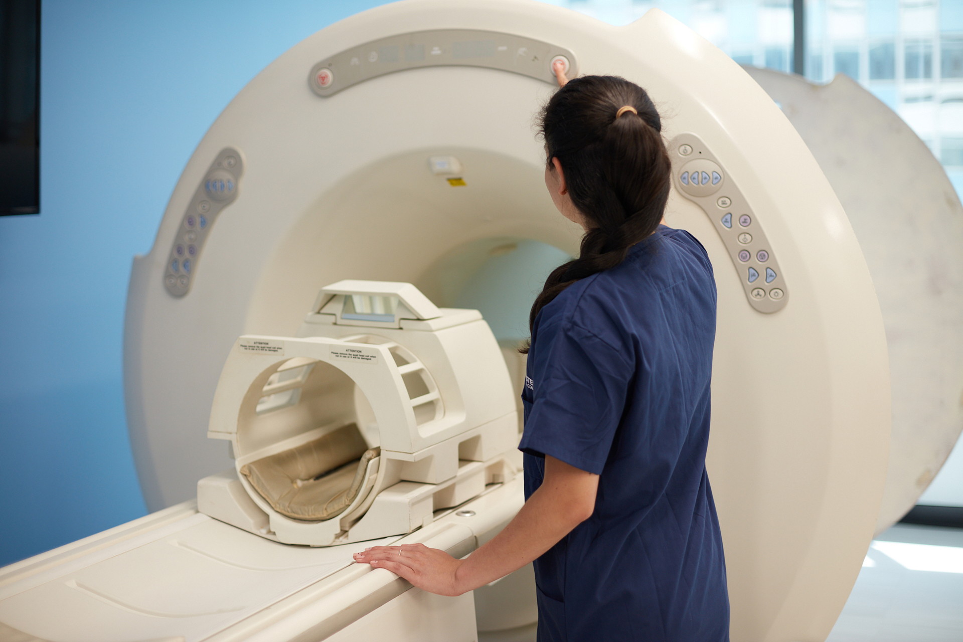 Midwestern Career College MRI student in front of MRI machine at Chicago Main (LaSalle) campus, highlighting ARMRIT accreditation through 2030.